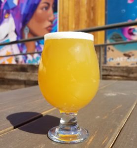 hazy yellow ipa beer on a table