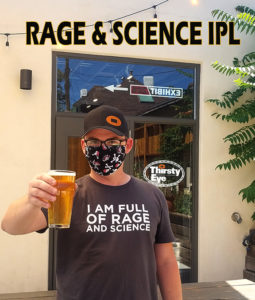 our brewer standing and holding a glass of India Pale Lager